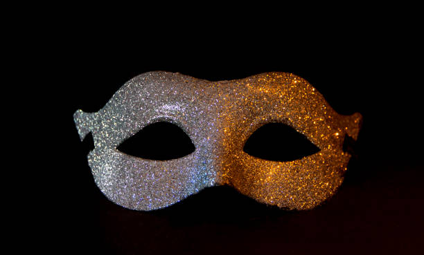istock carnival symbol mask in silver on a black background 1365753636
