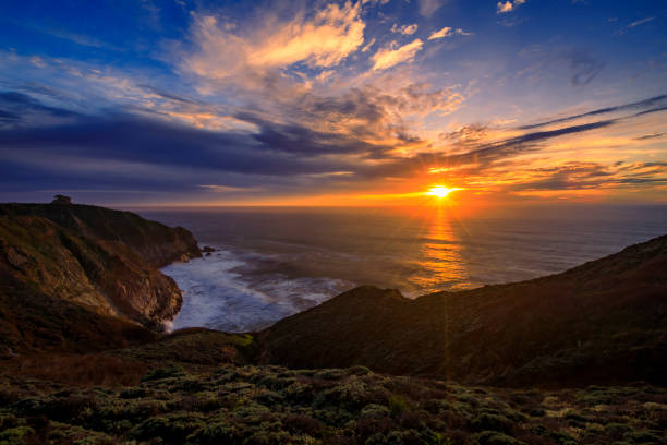 istock Rugged coastal cliffs by the Devil's Slide trail in California at sunset and silky ocean from long exposure 1365755031
