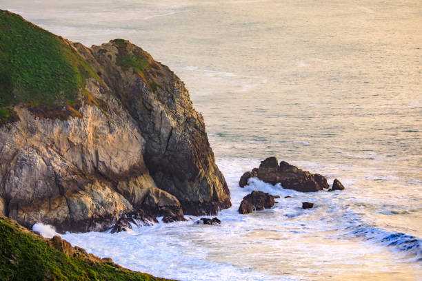 istock Rugged coastal cliffs by the Devil's Slide trail in California at sunset and silky ocean from long exposure 1365755034