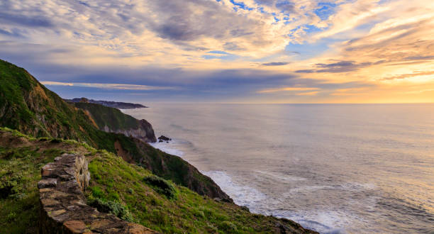 istock Rugged coastal cliffs by the Devil's Slide trail in California at sunset and silky ocean from long exposure 1365755040