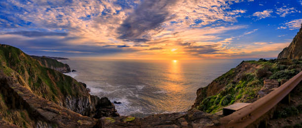 istock Rugged coastal cliffs by the Devil's Slide trail in California at sunset and silky ocean from long exposure 1365755046
