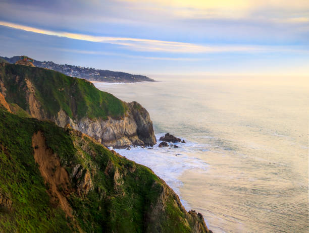 istock Rugged coastal cliffs by the Devil's Slide trail in California at sunset and silky ocean from long exposure 1365755047
