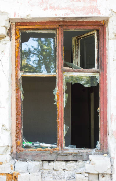 istock Old wooden broken window in a brick house 1365757194