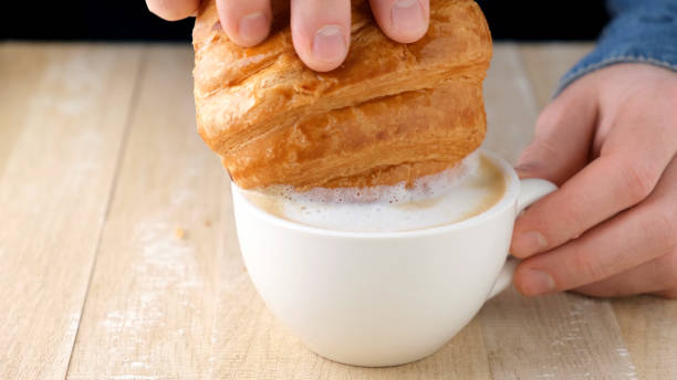 istock Dip croissant in coffee 1365758865