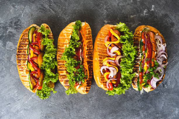 istock Four tasty Hot Dogs on a table. 1365760064