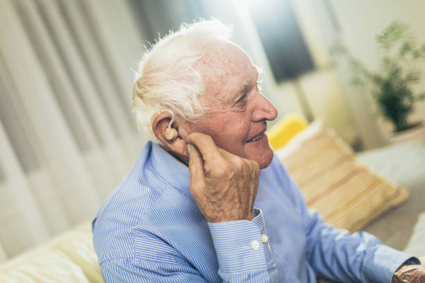 istock Senior man wearing hearing aid 1365762581