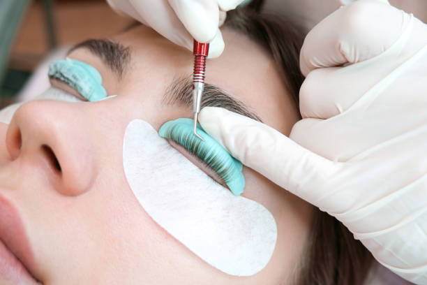 istock Young woman doing eyelash lamination procedure in a beauty salon 1365762644