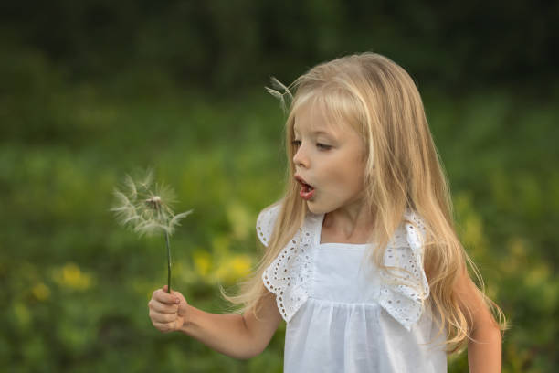 istock girl whit dandelion 1365762757