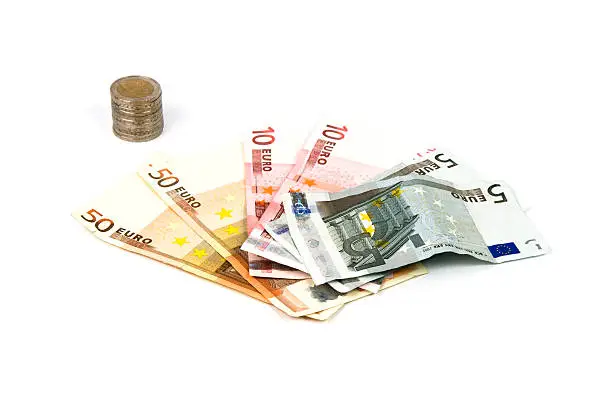 Euro coins and banknotes on a white background