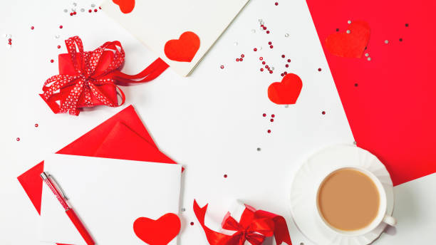 istock Valentine's day composition with coffee cup and box of paper red hearts on white background. from above. Space for text. Love and Valentine's Day concept. Top view, flat lay. 1365765529