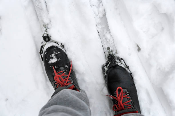 istock Ski boots and skis in the snow. 1365768586