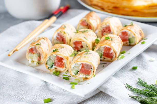 istock Rolls of thin pancakes with smoked salmon and cream cheese. Maslenitsa 1365772905