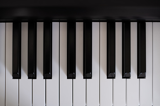 Close-up view of traditional piano keys.