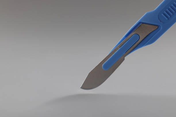 Sterilized sharp scalpel, mess, blades on the blue wrap