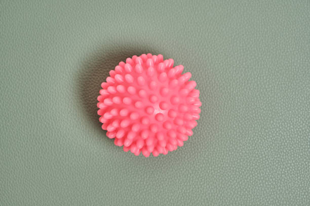 istock Pink prickly ball on a green background. 1365780366