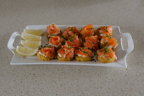 istock Smoked Trout on potato Rosti snack with lemon on a white serving platter 1365781901
