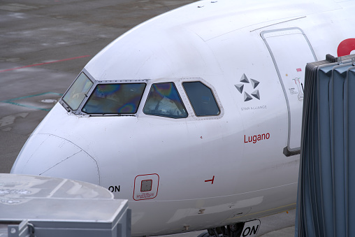 Close-up of cockpit with pilots of Swiss airplane Airbus A321-212 register HB-ION stationary at Zürich Airport on a cloudy winter day. Photo taken January 8th, 2022, Zurich, Switzerland.