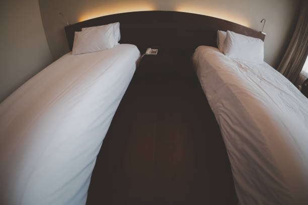 An empty hotel or motel room with two beds