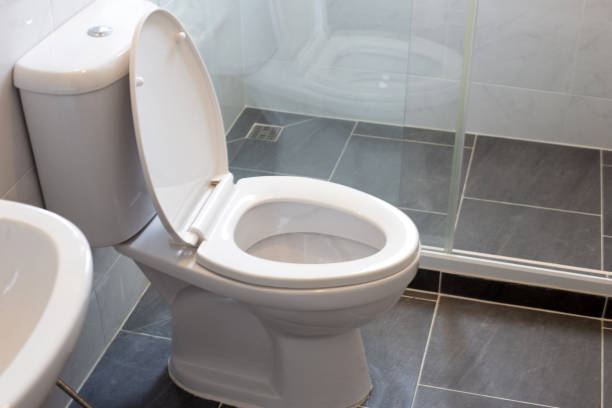 White toilet bowl on floor White toilet bowl on floor toilet stock pictures, royalty-free photos & images