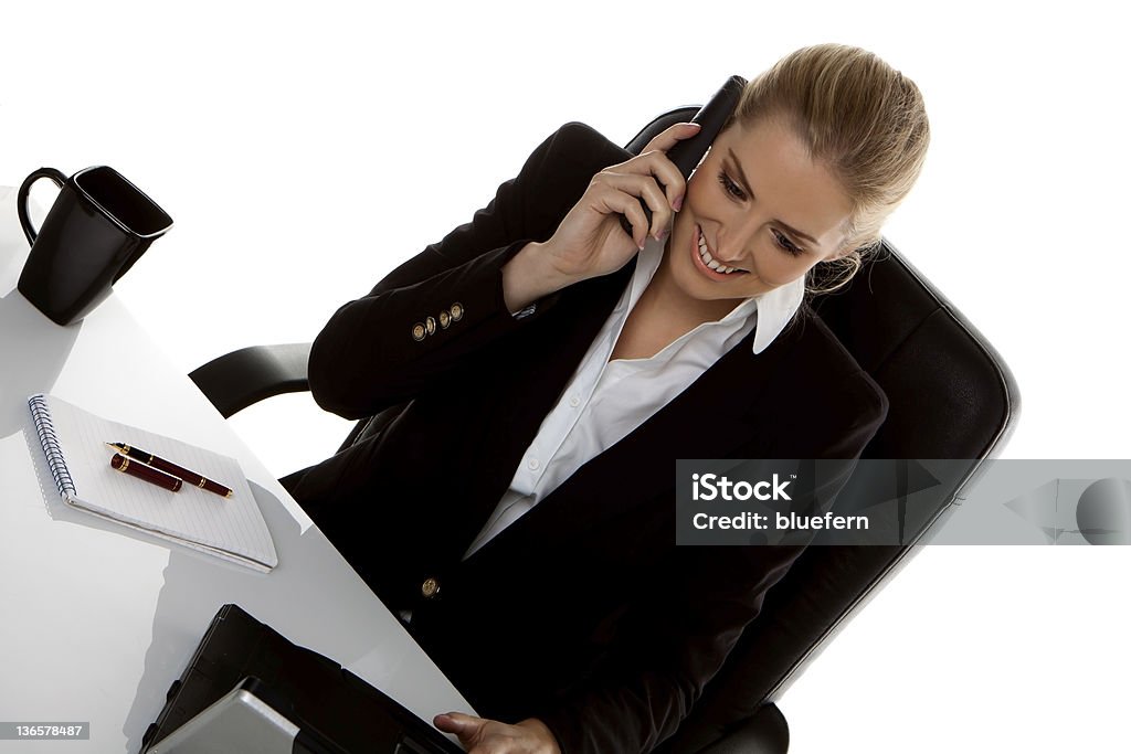 Businesswoman. A successful businesswoman sitting at her desk and talking on the phone. Landline Phone Stock Photo