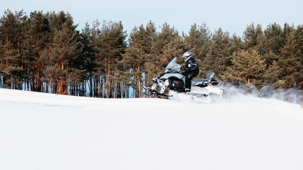 istock In deep powder snowdrift snowmobile rider driving fast. 1365785367