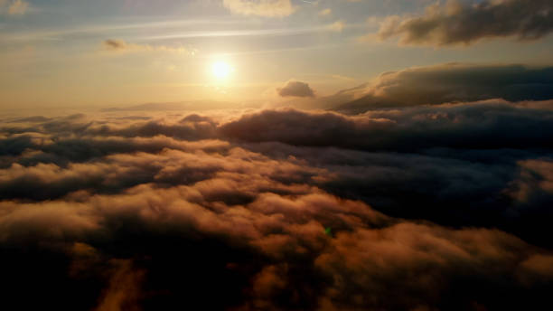 istock Aerial view: Over Clouds on Sun Rise in Mountains. 1365789311