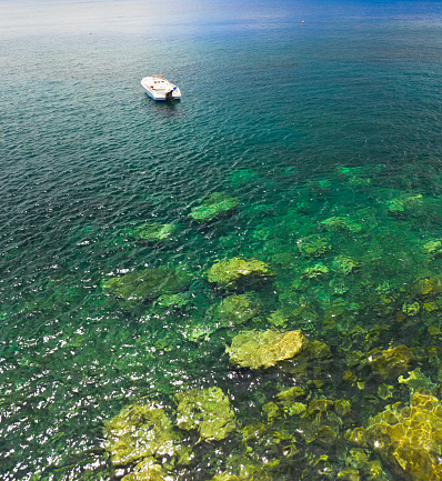 Coast of Lipari island in Italy with moored boat