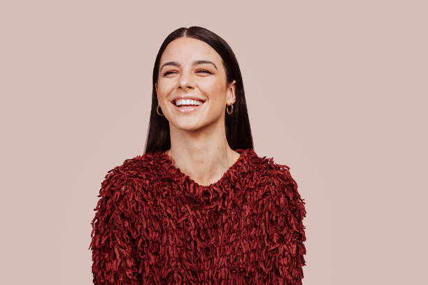 istock Young beautiful happy woman looks in camera at studio 1365789636