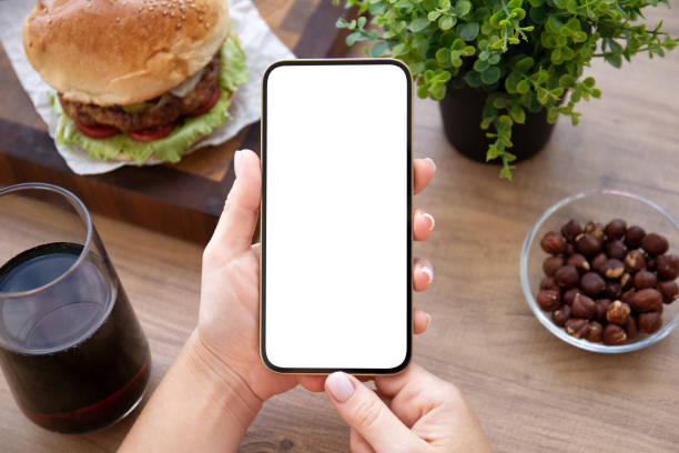 istock female hands holding phone with isolated screen background burger cafe 1365790361