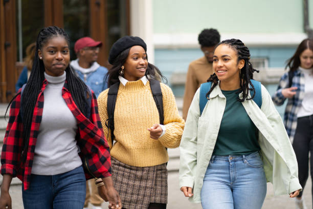 istock Mixed race group of female students going to University 1365791142