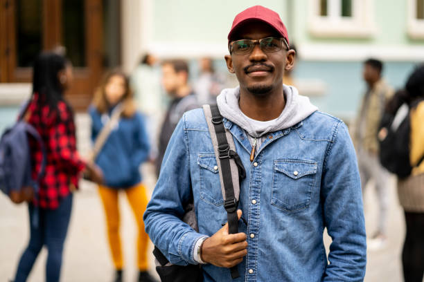 istock Handsome African-American student standing in the University yard 1365791150