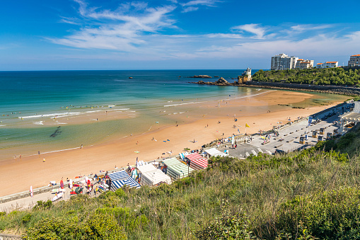 Cote des Basques beach in Biarritz with surf school tents set up along the seaside, France