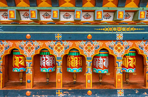 Decorated wine red door frame around entry door inside Padmasambhava Vihara of Namdroling Buddhist Monastery  in Bylakuppe, Mysore district, Karnataka, India