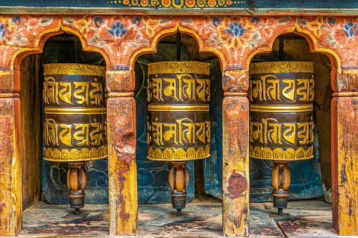 Prayer Wheels in the Tashichho Dzong (Thimphu Dzong), a Buddhist monastery and fortress on the northern edge of the city of Thimphu in Bhutan.
