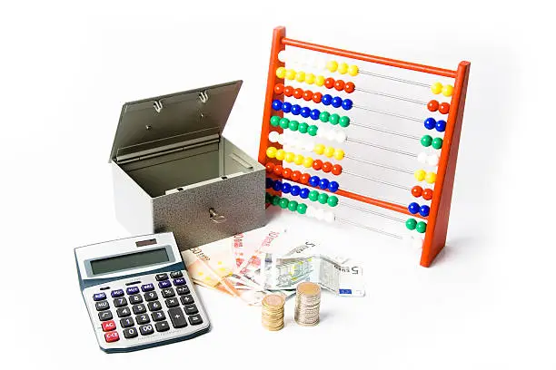 Euro coins and banknotes,calculator,money safe,abacus on a white background