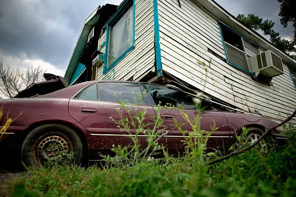 A house sits on top of a car in Ward 9, New Orleans, 21 days after the hurricane.