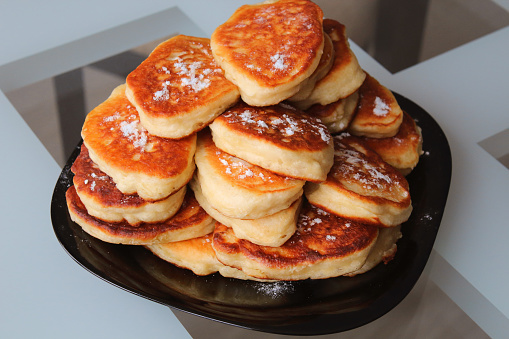 Fresh pancakes on a plate on the table. Close-up. Background.