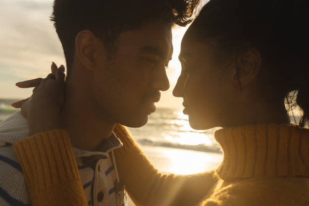 istock Romantic multiracial couple face to face looking at each other during sunset 1365806162