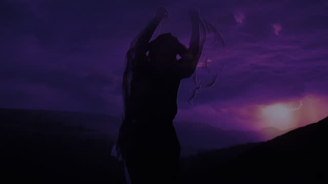Silhouette of a Dancing Woman against night storm lightning