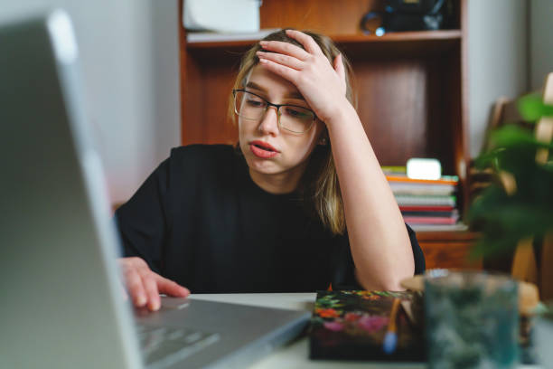 istock One woman young female working on laptop computer tired and sad having problem with bad college entry test results refused - student hold her head hard lesson education and learning concept copy space 1365812799