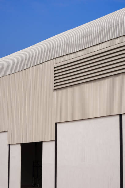 istock Corrugated steel with concrete wall of warehouse building structure is under construction against blue clear sky background 1365812924