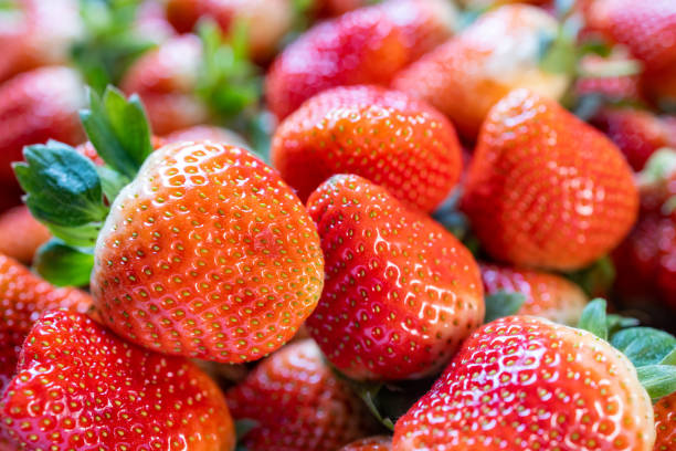 Some freshly picked strawberries, stacked on the table. Close-up shot with a Canon R5.