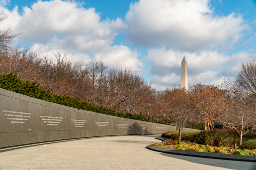 Washington DC, USA - April 12, 2015: Tourists gather under the Martin Luther King, Jr. Memorial in West Potomac Park. MLK Jr. is considered the most prominent leader in the African-American Civil Rights Movement.
