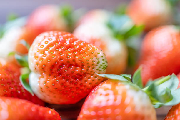 Some freshly picked strawberries, stacked on the table. Close-up shot with a Canon R5.