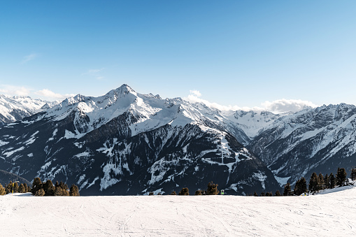 Panoramic view of snowcapped mountains. illuminated by sun Winter. beautiful clear blue sky in daylight. impressive view of mountain peaks. tourism. Climbing the mountains. Ski resorts. snowy valley.