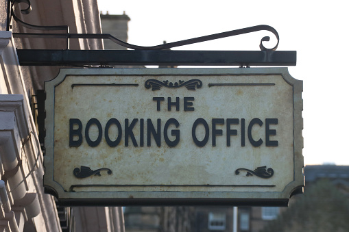 Victorian booking office sign at an old railway station