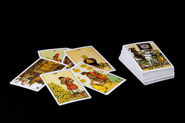 istock Tarot Cards Scattered on a Black Table Top 1365818332