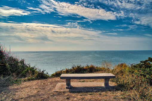 Holidays in France, a stone bench could be a place to rest and enjoy the great view over the north sea.