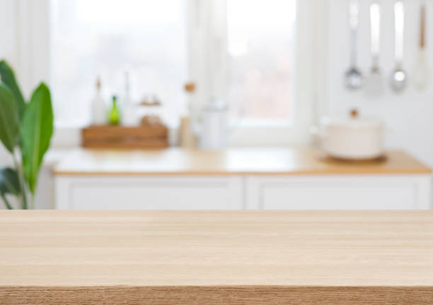 Empty wooden desk on blurred kitchen window for product presentation stock photo