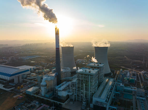 istock Aerial view power station with smoking at sunset 1365823081